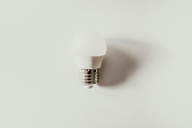 A minimalist photo of an LED light bulb against a white background emphasizing simplicity and modern design.